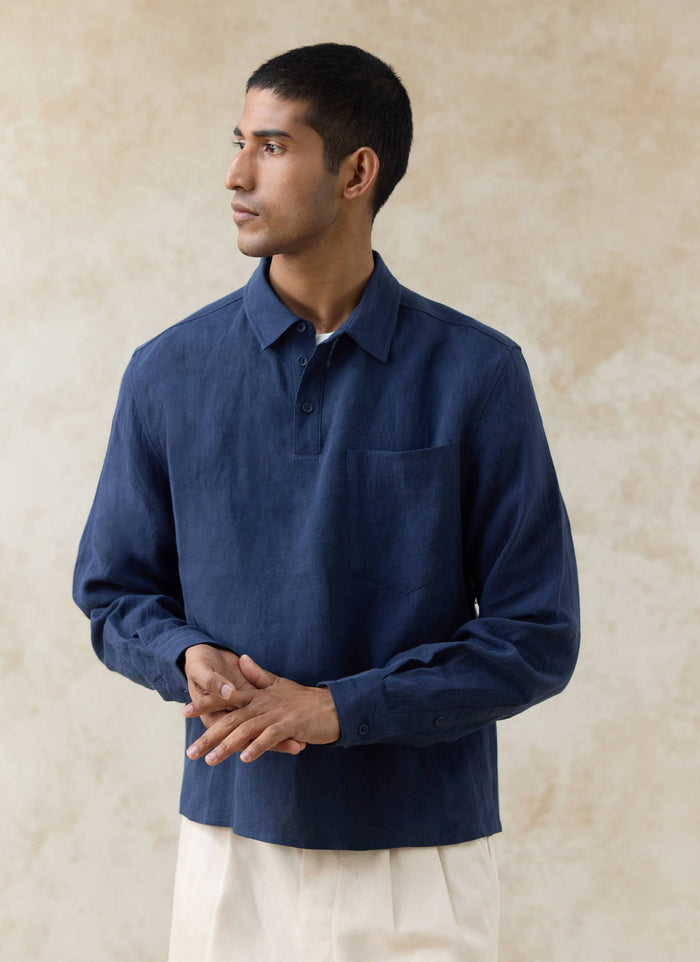 The Percival Alec Pullover Cropped Shirt in navy linen, featuring a half-placket and chest pocket on a model.