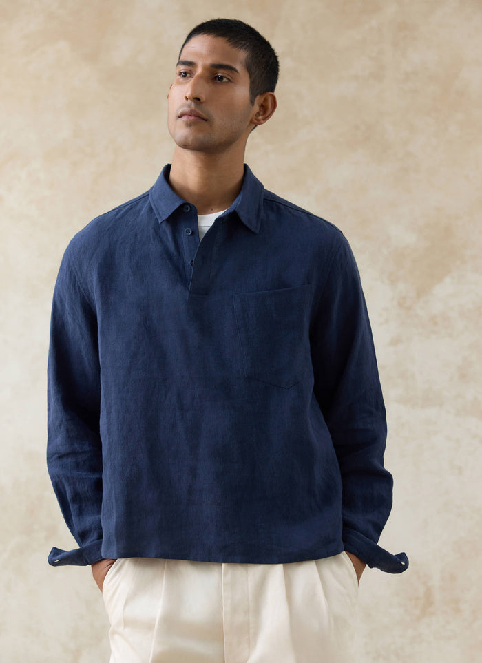 The Percival Alec Pullover Cropped Shirt in navy linen, showing the half-placket and chest pocket on a model.