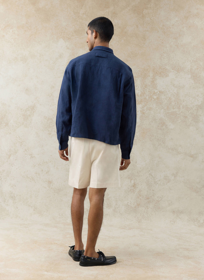 The Percival Alec Pullover Cropped Shirt in navy linen, featuring a boxy fit, shown from behind on a male model.