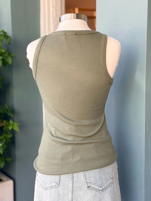 Mannequin wearing a green tank top against a neutral background