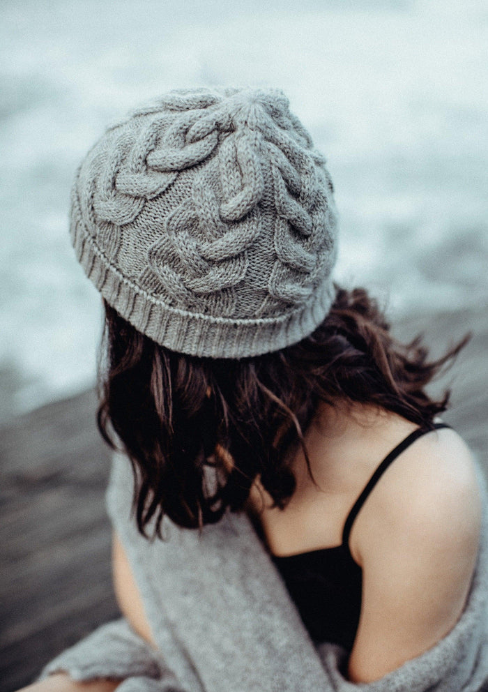 Woman wearing a light grey beanie outside