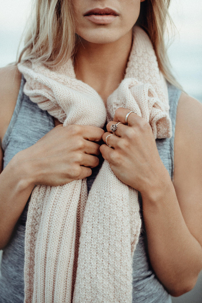 Woman wearing a pink Alpaca Patch Scarf