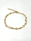 Gold bracelet with heart-shaped links on a white background