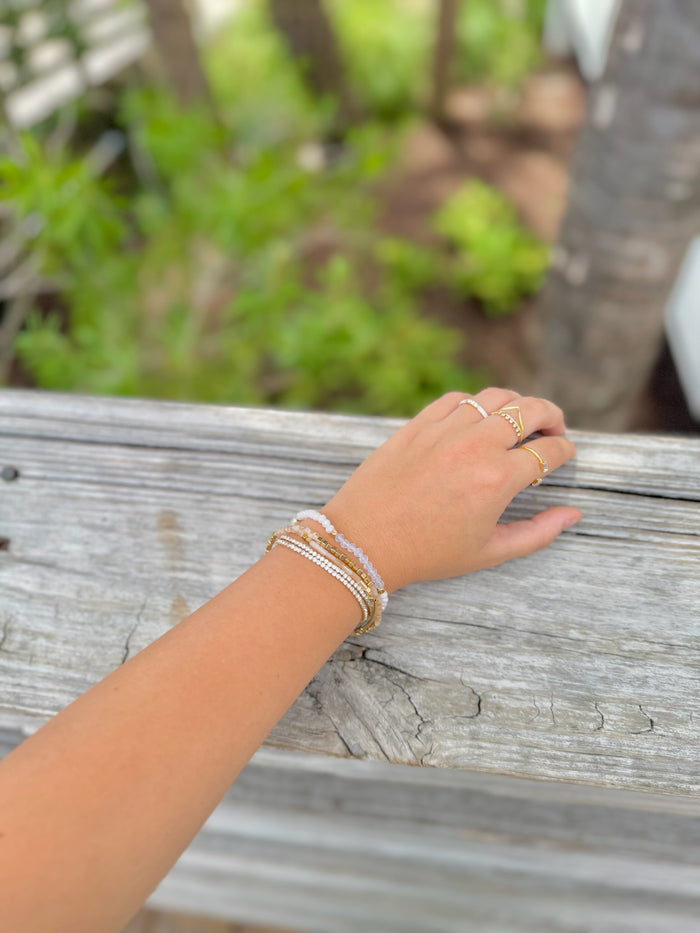 Amelie Bracelet Stack with pearl, blush, crystal, and gold beads on models arm