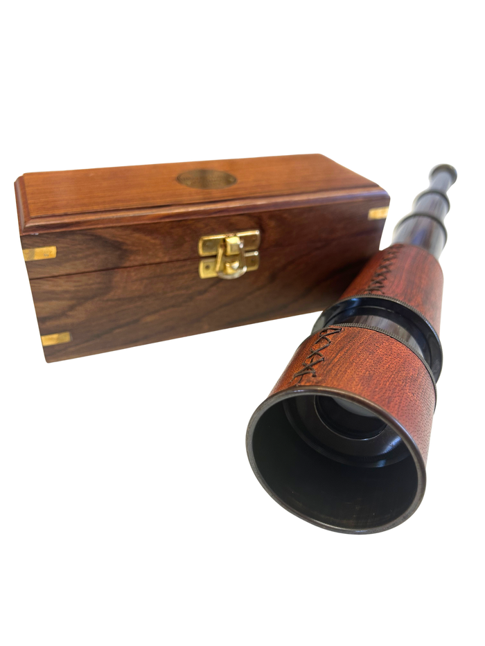 Spyglass beside wooden box
