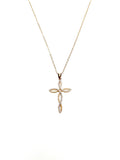 Gold cross pendant necklace on a white background