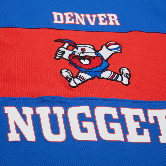 Up close view, a red chest stripe with a retro miner mascot logo and white 'DENVER NUGGETS' text
