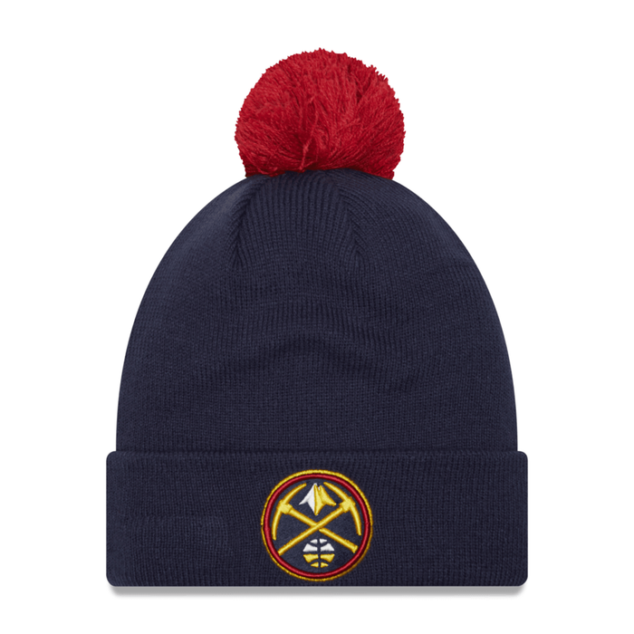Front view dark navy blue knit beanie with a red pom-pom on top and a Denver Nuggets team logo patch on the folded cuff.