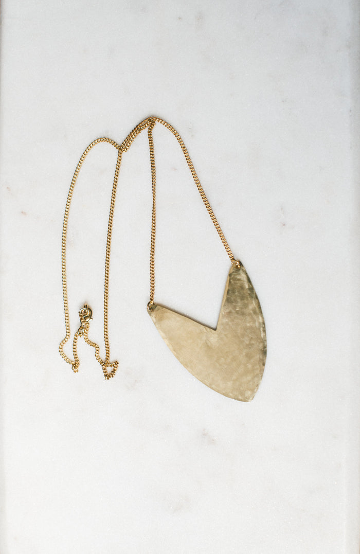 Brass Tulip Necklace on display
