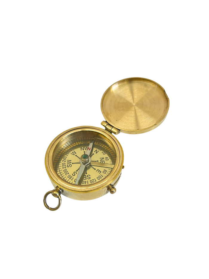 Brass compass on a white background
