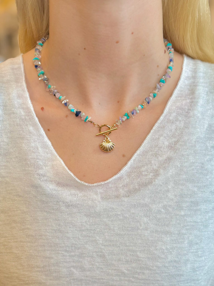 Isabelle Shell Necklace with gemstone-style beads and gold-tone shell charm on models neck