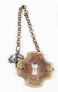 Bracelet featuring key plate and crystal charm