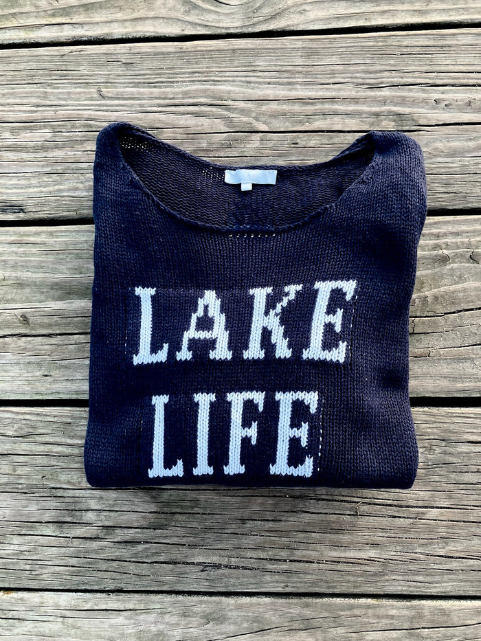 Cotton acrylic navy Lake Life sweater folded on wooden dock from Ardor Boutique