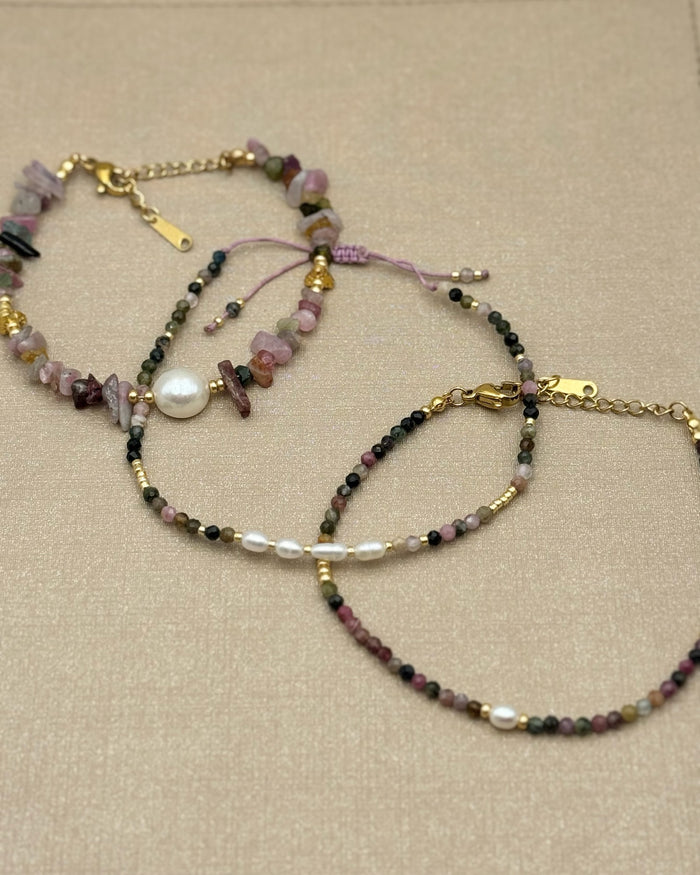 Tourmaline & Pearl Bracelet on beige background with other tourmaline bracelets