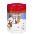 Luxury Tea Maple Tea packaging with red lid and winter scene design.