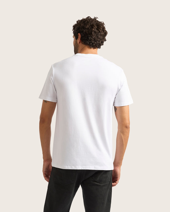 Man wearing a plain white t-shirt against a light background