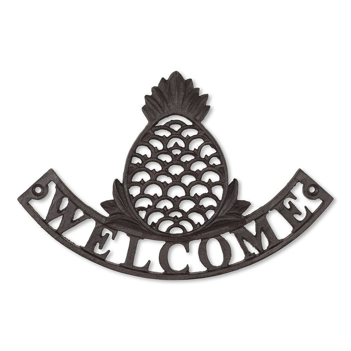 Cast iron sign with a pineapple over the word "welcome"