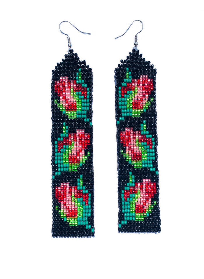 Close product shot of beaded earrings, each with 3 red and pink rosebuds on a black background.