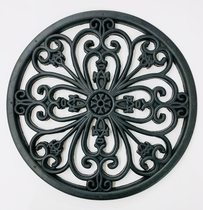 A round rubber stepping stone with wrought iron styling