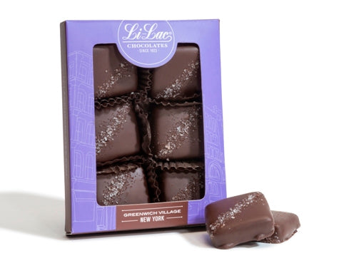 A purple card stock window box holds six Salted Caramel squares.
