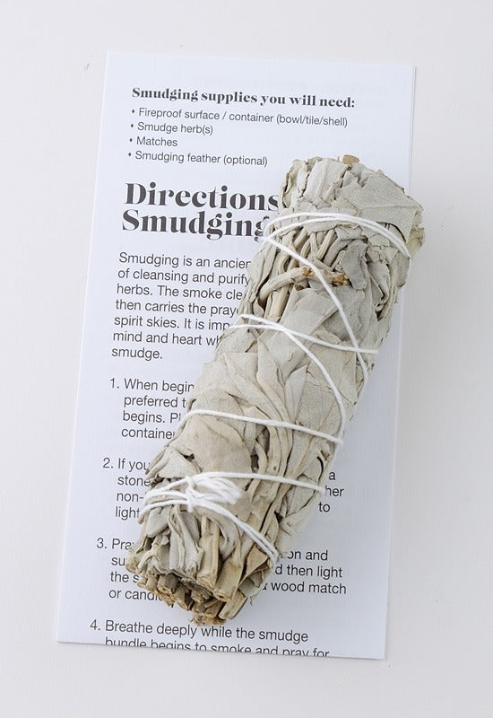Small sage smudge bundle shown with instructions
