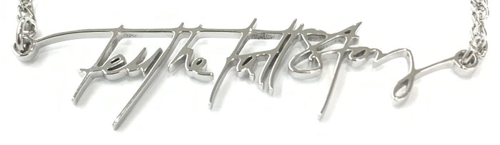 Close up of "Tell the Full Story" in stainless steel custom handwriting