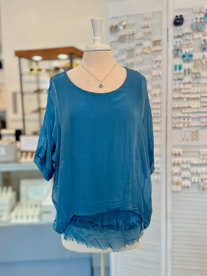 Blue top on a mannequin in a store setting