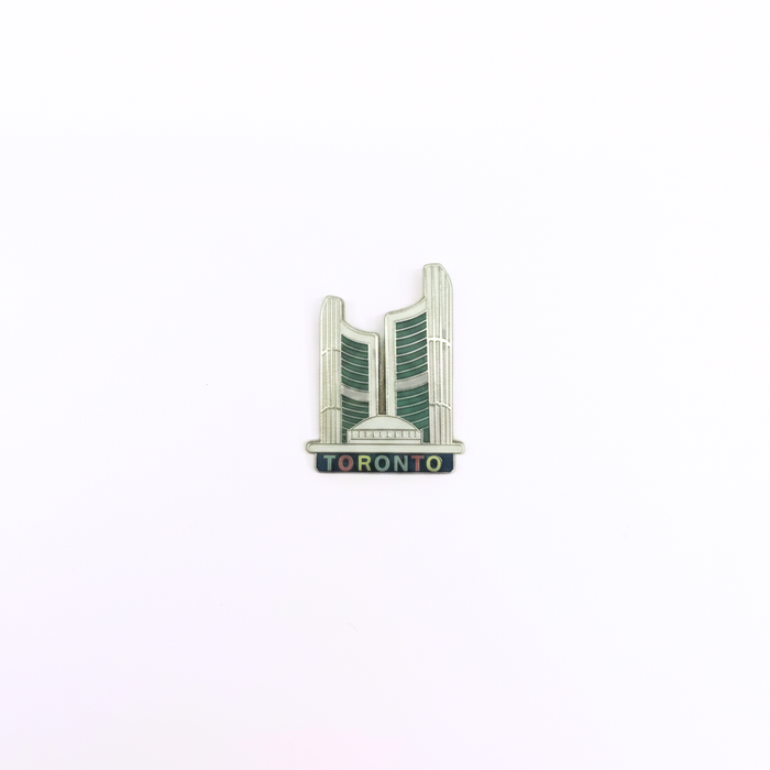 Pin with a stylized depiction of the city hall building and 'Toronto' text on a white background