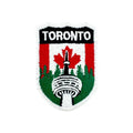 Embroidered patch with 'Toronto' text and a design of the CN tower and trees on a red and green background.