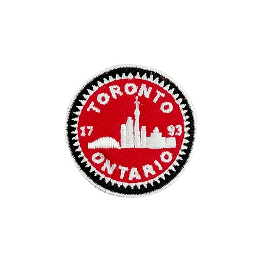 Circular patch with 'Toronto, Ontario' text and skyline on a red background