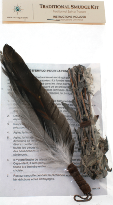 Close product shot of smudge kit showing feather, sage and instructions