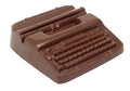A molded chocolate typewriter has keys and carriage details.