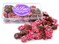 Nonpareils in a clear acrylic box, they are decorated with red, pink and white nonpareils candies.