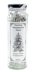 Jar of Victorian Christmas tree tinsel with a decorative label on a white background