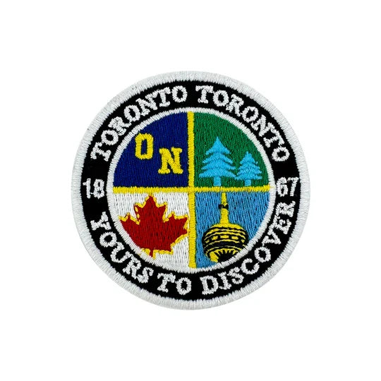 Circular patch with Toronto-themed design on a white background